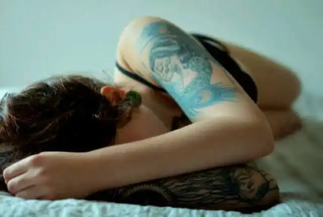 girl with tattoo sleeps